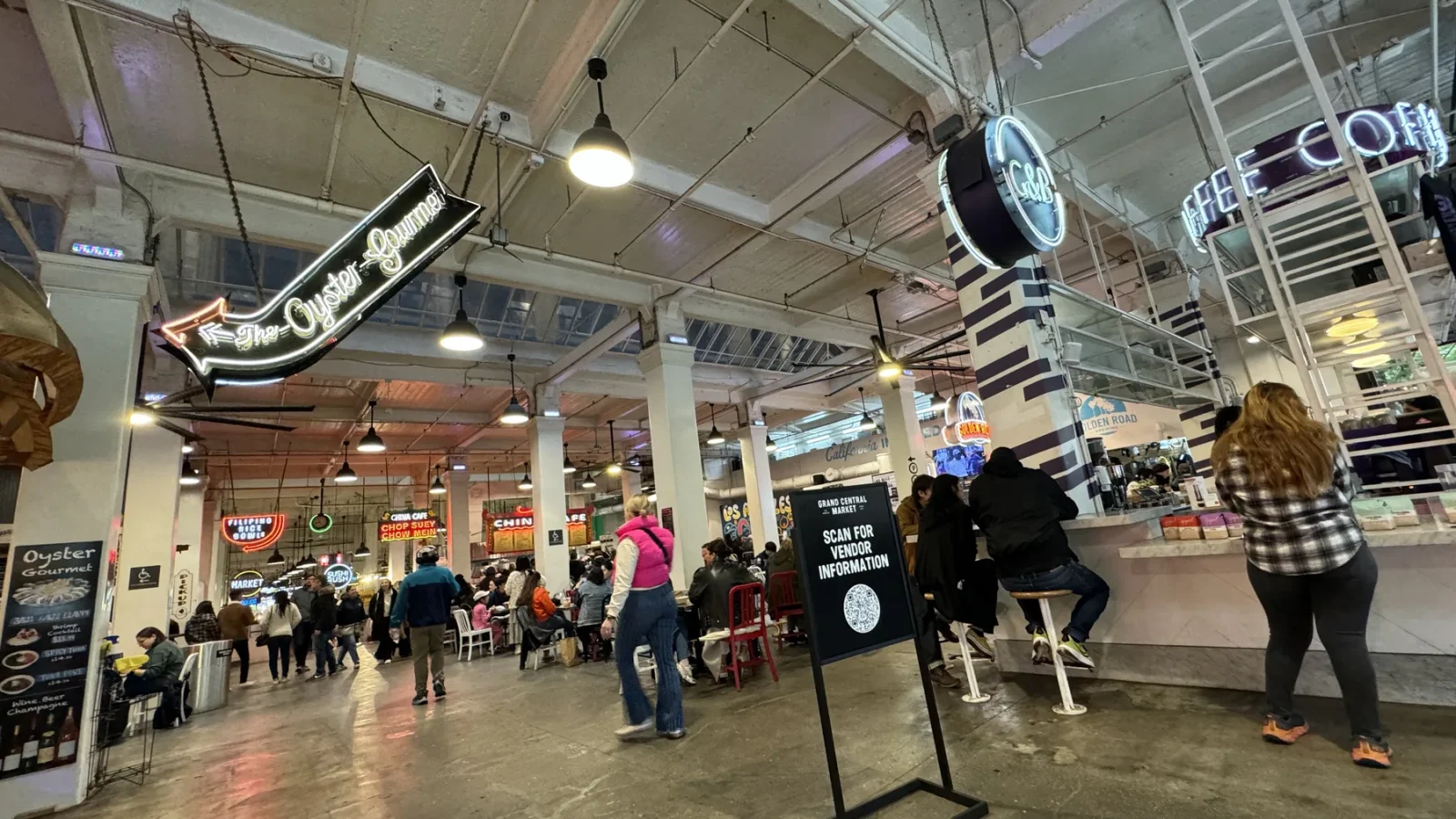 Food counters and illuminated signs inside Grand Central Market in downtown Los Angeles