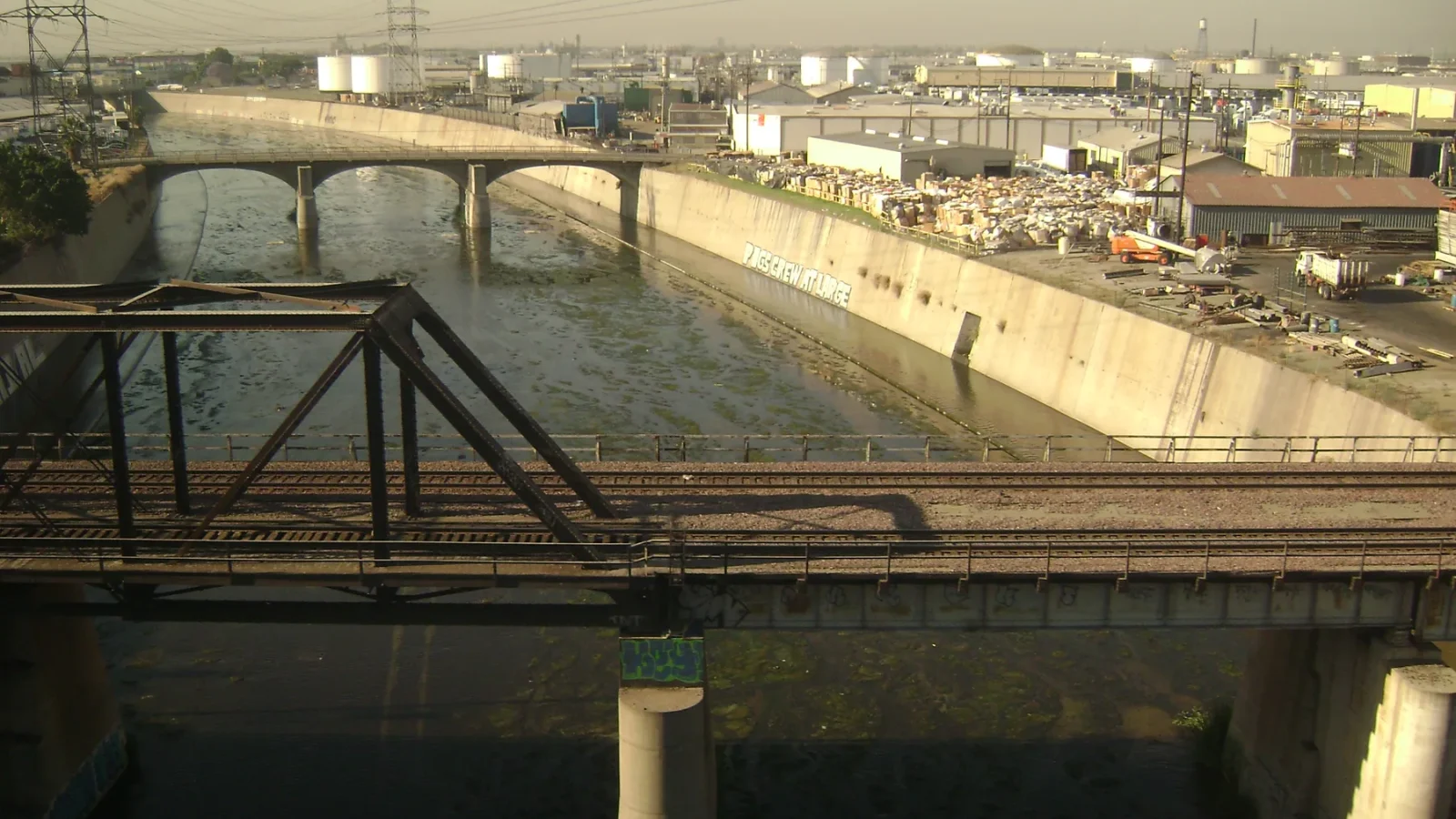 Rail and road bridges crossing the concrete channel of the Los Angeles River
