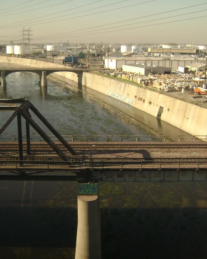 Rail and road bridges crossing the concrete channel of the Los Angeles River