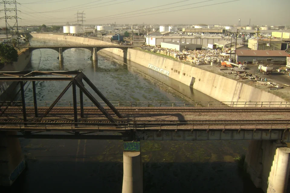 Rail and road bridges crossing the concrete channel of the Los Angeles River